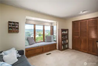 Guest bedroom with window seat to enjoy some sneak peeks of the channel!
