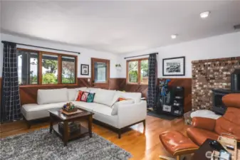 Family room with gas fireplace, wood floors and custom wainscoting. Walk out to the spacious backyard and sundeck.
