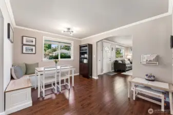 Dining room. Lots of light, updated floors, vinyl double pane windows & white millwork.