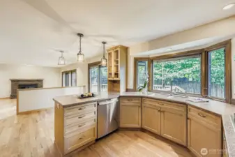 The spacious kitchen continues into the breakfast area and a step down to the family room. Both rooms have Pella sliding doors that access the deck and backyard.