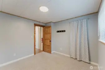 Versatile bedroom with natural light, suitable for guests, office use, or hobbies.