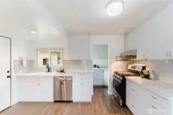 Thoughtfully updated kitchen featuring stainless steel appliances, ample cabinetry, an efficient layout and even a butler's pantry!