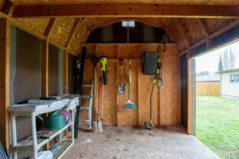 Inside the clean, well-kept shed there's even additional storage in the loft space.
