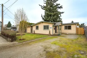 Quiet residential setting with a spacious front yard, RV parking with water and 30 AMP hook up, and plenty of off-street parking.