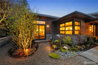 In this photo, you see the double doors leading intio the primary suite.  The windows to the right are the master bathroom.