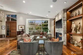 The living room...vaulted ceiling, gas fireplace flanked by built-in shelving on both sides.