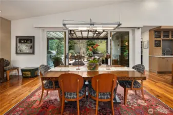 In the same greatroom, the dinig area which opens out to teh covered patio, the garden & BBQ station.