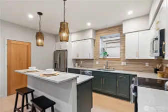 Complete with quartz countertops, stainless steel appliances and a pantry closet, this kitchen has everything you need.