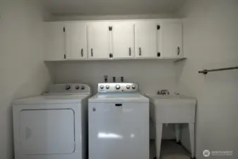 Laundry area with utility sink and cabinets - washer and dryer are included!