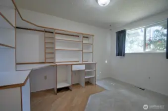 Second main floor bedroom with built-in desk and bookcase
