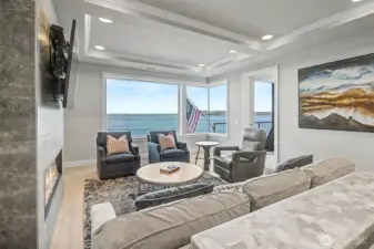 Light-filled living area with expansive windows framing dynamic waterfront views.