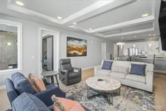 Inviting living room with clean lines, 10-foot coffered tray ceilings, and a modern, cohesive design.