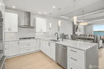 Chef’s kitchen with quartz waterfall-edge countertops and Bosch stainless steel appliances.