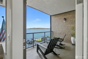 Covered balcony provides a peaceful setting to enjoy fresh saltwater air year-round.