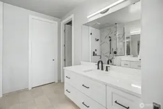 Custom cabinetry enhance the spa-inspired primary bath.