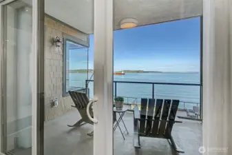 Seamless indoor-outdoor connection leads from the suite to the private waterfront balcony.
