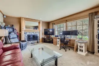 French doors lead you into the sunny living room located at the front of the home, featuring a rock wood burning fireplace with a wood mantle as the focal point. Other highlights include wood wrapped Marvin windows and custom pine crown molding.