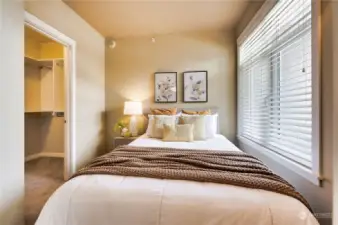 A true bedroom with cool walk-in closet & custom shelving.