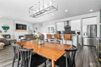 Looking back across the kitchen and livingroom. Note the custom pantry sliding doors added by the sellers.