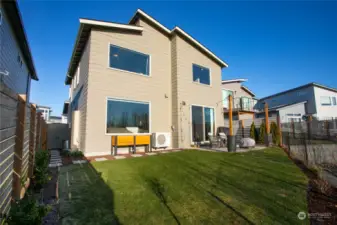 Beautiful, fully-fenced backyard, bathed in sunlight.