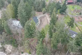 Property is to the right of the house.