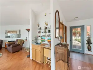 To right of entry, a wet bar and the living area.