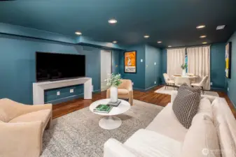 This versatile lower-level media room offers both function and comfort. With daylight walk-out access, it feels bright and open yet remains cozy and inviting. Luxury vinyl floors provide quiet durability, waterproof performance, and underfoot comfort. Excellent ceiling height, level floors, and plumbing for a future sink or wet bar make this space as practical as it is stylish.