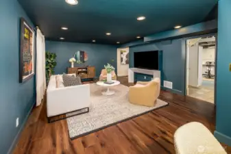 Another view of the bonus room space looking towards the other portion of the lower level.  All blackout curtains and hardware transfer with the home.