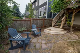 Lower level patio space just off of lower level entrance with flagstone pattern.