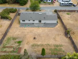This property has two parcels for .29 of an acre. The lower left-hand corner has raised garden beds, and underground power is run to this area for a potential shop or garage. You can easily move an RV or boat through the double gate on the uppper left-hand corner of the property.
