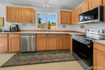 This wonderful, spacious kitchen has oodles of storage and counter space, and you may even enjoy doing the dishes as you overlook your spacious back yard.