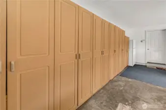 This fantastic wall of garage shelving can hold all of your seasonal and prize possession. The fridge at the end stays with the house, and the door on the right leads to the utility room.