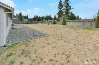 This shy 1/3 acre property is mostly flat and ready for your backyard enjoyment.  The far back corner is the drain field, and to the right there is underground power run to the corner for a potential second garage or shop.