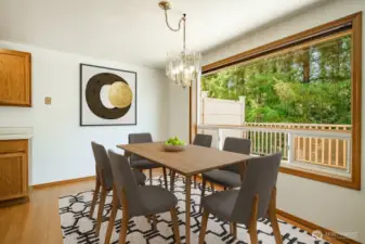 Virtually staged: Dining area overlooking the large deck and woods