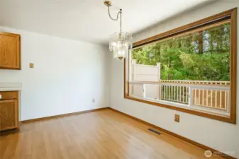 Dining area overlooking the large deck and woods