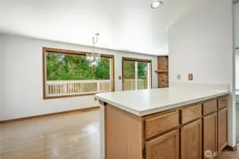 Kitchen/Dining flowing to large backyard deck.