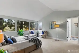 The primary suite is a sanctuary with windows of nature.