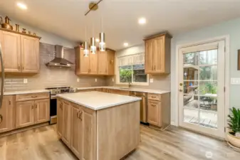 Notice the tilework behind the countertops. There's easy access to the back yard and covered cabana.