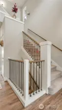 Open and bright entryway featuring a beautifully designed staircase with modern, open detailing that sets the tone for the home's simplistic design.