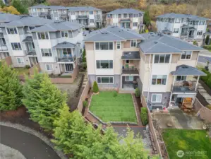 Beautifully landscaped backyard with a grassy area for play.