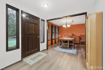 Wide entry through solid wood door welcomes all!  Flanking windows bring in the natural light.