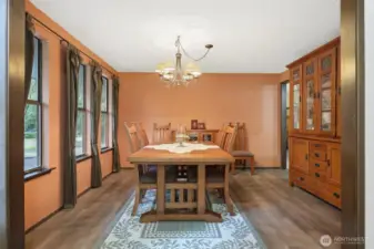 Classic dining room offers continuation of the natural light in a trio of double hung windows, and highlights new LVP flooring. Room enough for hutch and buffet, as well as an expanding table when needed.
