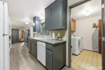 From the other side of the kitchen you'll see the garage door, as well as one of two handy entry points to the laundry room.