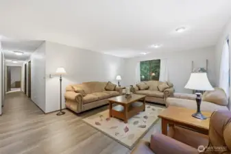 Back in the front of the home again, this well-lit hallway from the living room takes us to the bedrooms.