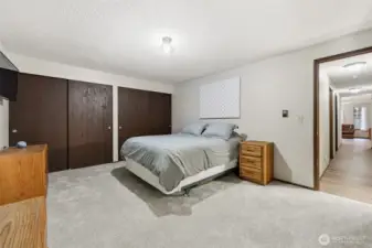 Primary bedroom offers generous space, two closets, fresh paint, and new--SOFT--carpet!