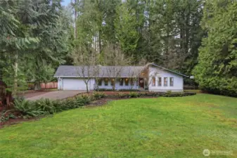 Situated on this spacious lot with the slightest rise toward the house, it is set back from the street and perfectly placed among the evergreen trees. New roof and gutters in 2024, new exterior paint for buyer once weather allows!
