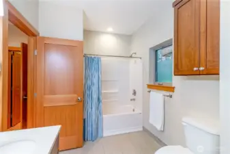 Primary bathroom with tub and shower combination