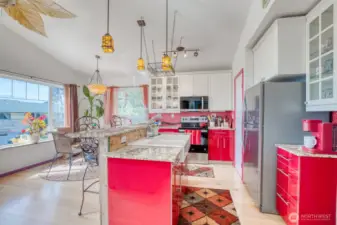 Kitchen with breakfast bar and eating area.