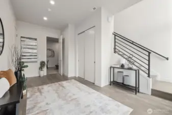 Large entryway that leads to the game room/family room/tv room and then upstairs to great room