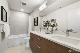 Guest bathroom on upper level with dual sinks